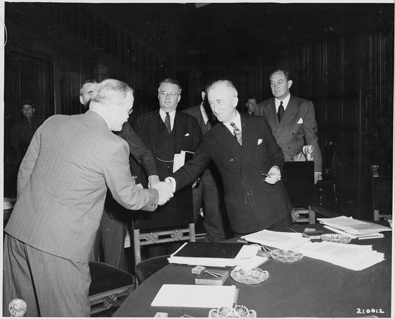 Soviet foreign minister Vyacheslav Molotov, left, shakes hands with Secretary of State James Byrnes before the commencement of a session of the Potsdam Conference