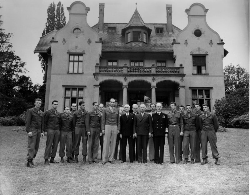President Harry S. Truman (eighth from the right) and members of his party with the staff of the Little White House on the south lawn