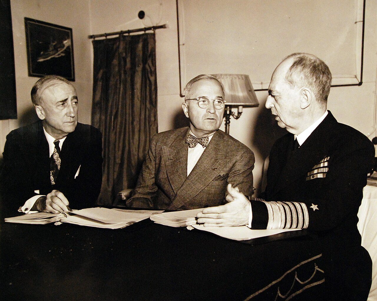 80-G-49927: Potsdam Conference, 17 July – 2 August 1945. President Harry S. Truman onboard USS Augusta (CA 31) en-route to Antwerp for the “Big Three” Conference. Shown: (left to right) Secretary of State James F. Byrnes, President Truman, and Admiral William D. Leahy, USN, in Mr. Byrnes cabin. Photograph received July 18, 1945. U.S. Navy Photograph, now in the collections of the National Archives. (2016/02/23).