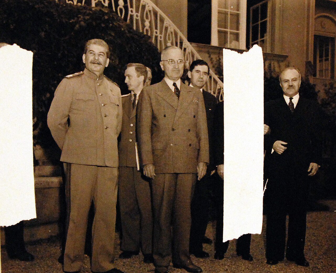 80-G-49960: Potsdam Conference, 17 July – 2 August 1945. Shown: President Harry S. Truman and Secretary of State James F. Byrnes visiting Premier Joseph Stalin and Foreign Commission V. Molotov at Stalin’s residence in the conference area, Potsdam, Germany. Men in Second Row are interpreters. Photographed by CPhoM Wm. Belknap, received July 18, 1945. U.S. Navy Photograph, now in the collections of the National Archives. (2016/02/23).