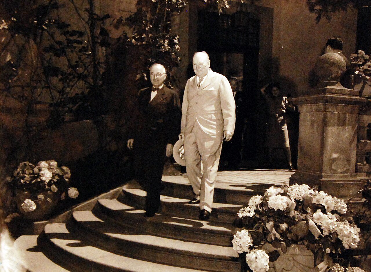 80-G-49967: Potsdam Conference, 17 July – 2 August 1945. Shown: Prime Minister Winston S. Churchill pays a visit to President Harry S. Truman at the “Little White House” in Potsdam, Germany. Photographed by CPhoM Wm. Belknap, received July 16, 1945. U.S. Navy Photograph, now in the collections of the National Archives. (2016/02/23).