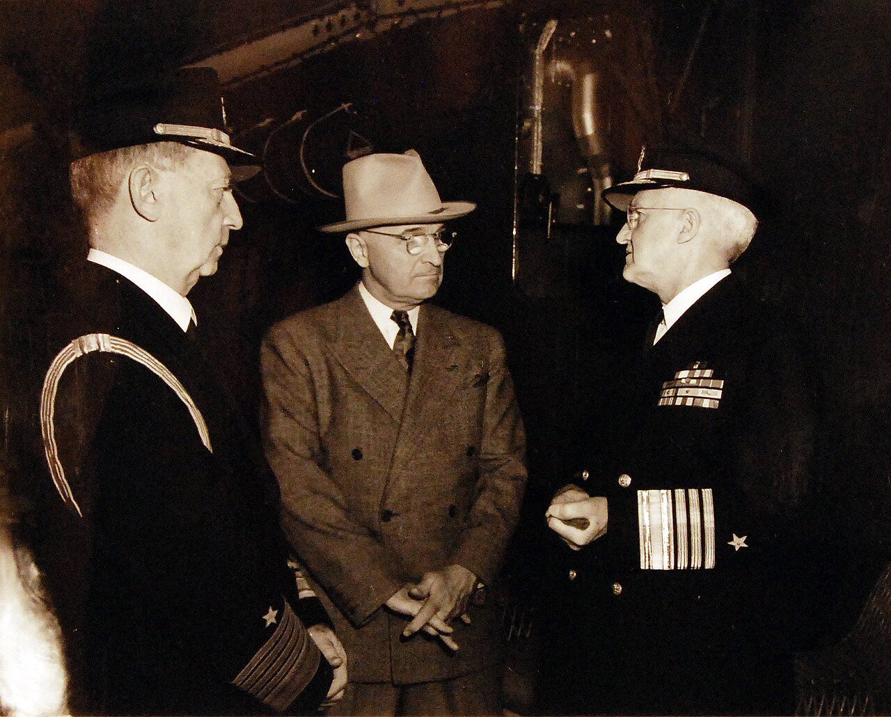 80-G-49970: Potsdam Conference, 17 July – 2 August 1945. Shown: Fleet Admiral William D. Leahy, President Harry S. Truman and Admiral Harold R. Stark conferring before the President left the ship at Antwerp, Belgium. Photographed by CPhoM Wm. Belknap, received July 15, 1945. U.S. Navy Photograph, now in the collections of the National Archives. (2016/02/23).