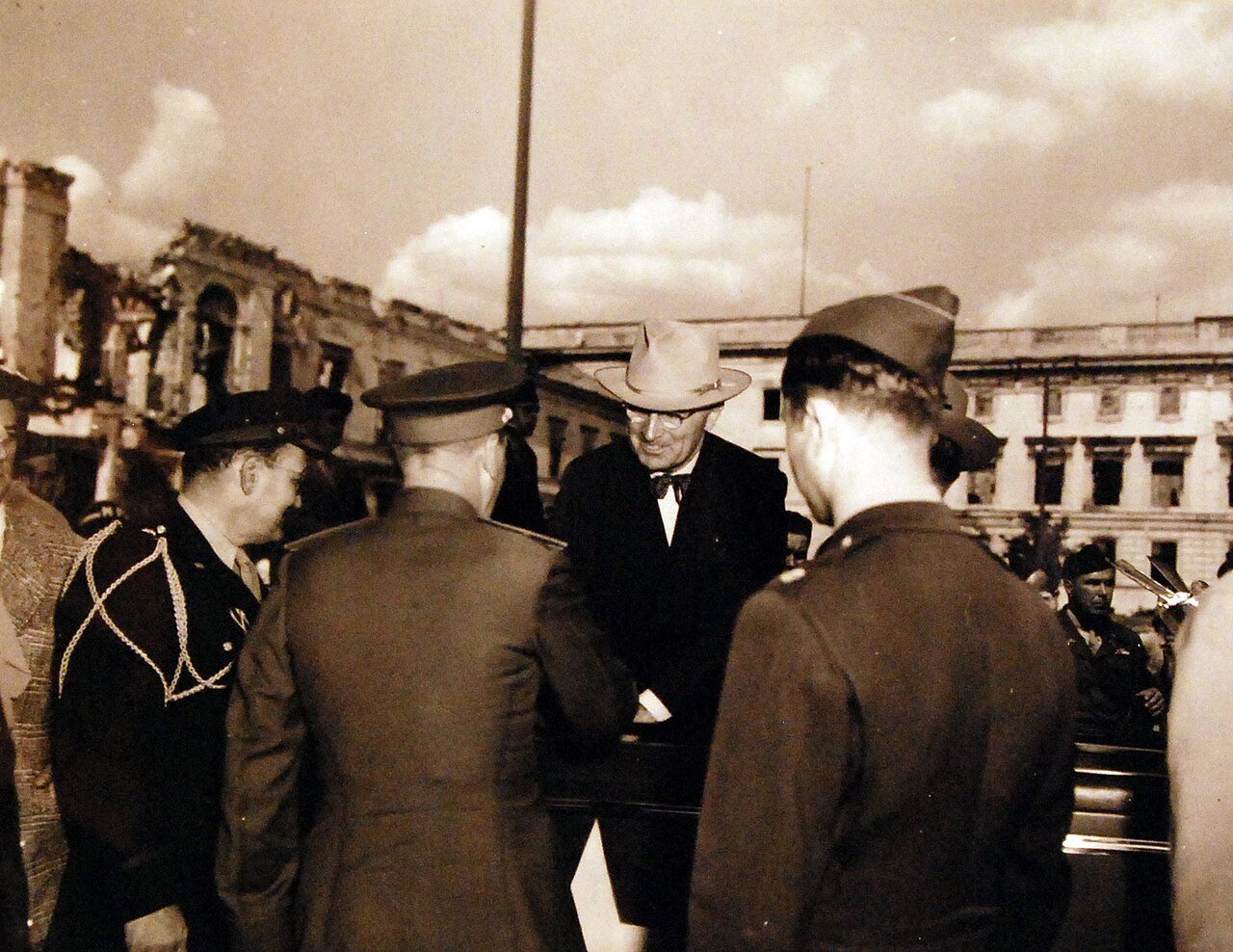 80-G-49972: Potsdam Conference, 17 July – 2 August 1945. Shown: President Harry S. Truman, Secretary of State James F. Byrnes in front of wreckage of Hitler’s Chancellery in the heart of Berlin, Germany. Photographed by CPhoM Wm. Belknap, received July 16, 1945. U.S. Navy Photograph, now in the collections of the National Archives. (2016/02/23).