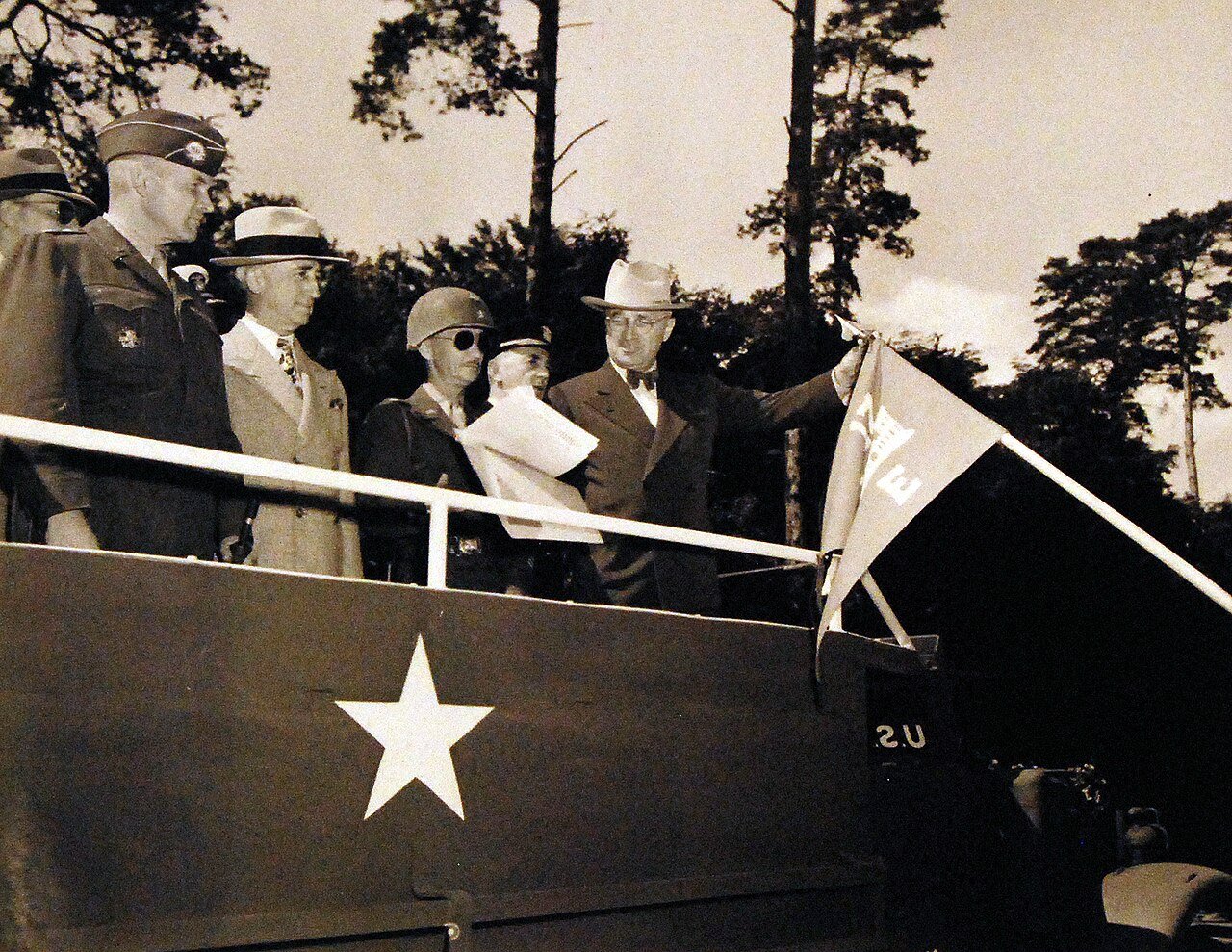 80-G-49977: Potsdam Conference, 17 July – 2 August 1945. President Harry S. Truman and party visiting 2nd Armored Division on outskirts of Berlin, Germany. Shown: President ties the Presidential Unit Citation streamer on the Guidon at the 2nd Armored Division. Left to right: Major General F.L. Parks, USA; Mr. Byrnes, Brigadier General John Collier; Admiral William D. Leahy, and the President. Photographed by CPhoM Wm. Belknap, received July 16, 1945. U.S. Navy Photograph, now in the collections of the National Archives. (2016/02/23).