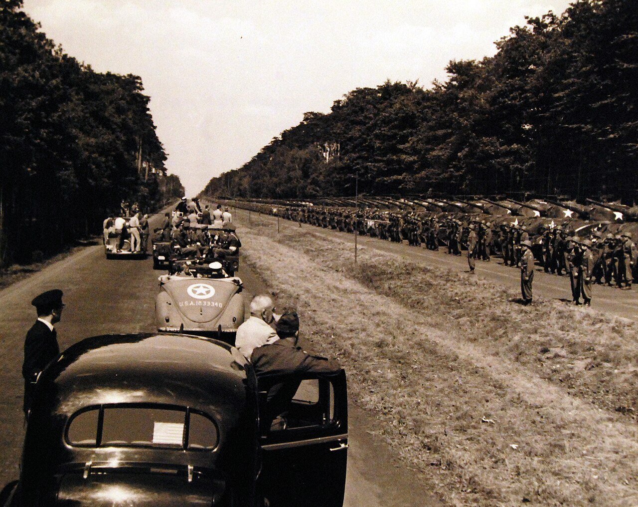 80-G-49985: Potsdam Conference, 17 July – 2 August 1945. In between conference sessions, President Harry S. Truman makes a quick tour of Berlin, Germany. Shown: On the outskirts of the city, he inspects the Second Armored Division. Shortly following this inspection, he presented the Division with the Presidential Unit Citation. Photographed by CPhoM Wm. Belknap, received July 16, 1945. U.S. Navy Photograph, now in the collections of the National Archives. (2016/02/23).