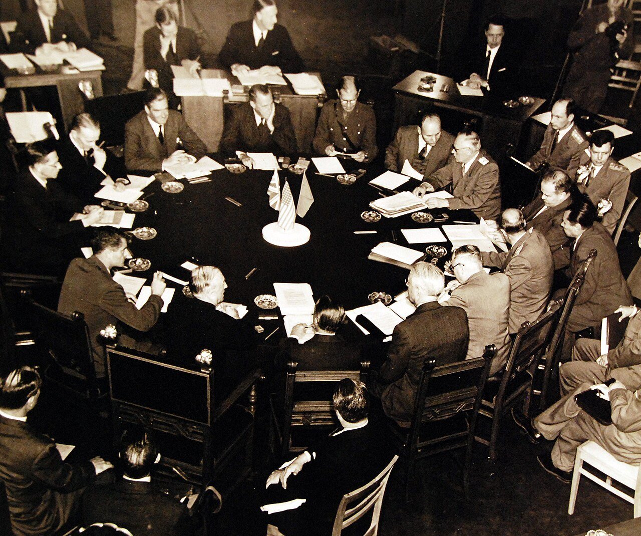 80-G-700117: Potsdam Conference, 17 July – 2 August 1945. The “Little Three” (Foreign Ministers) meeting in the same conference room as the Heads of States at Potsdam, Germany. Foreign Minister Anthony Eden at upper left, Secretary of State James F. Byrnes, with back to camera, Foreign Commissar V. Molotov, extreme right. Photographed released July 24, 1945. U.S. Navy Photograph, now in the collections of the National Archives. (2016/02/23).