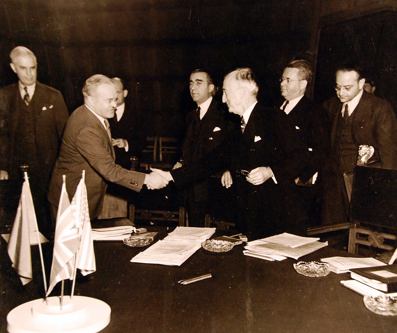 80-G-700119: Potsdam Conference, 17 July – 2 August 1945. The “Little Three” (Foreign Ministers) meeting in the same conference room as the Heads of States at Potsdam, Germany. Foreign Commissar V. Molotov being greeted by Secretary of State James F. Byrnes prior to opening. Photographed released July 24, 1945. U.S. Navy Photograph, now in the collections of the National Archives. (2016/02/23).