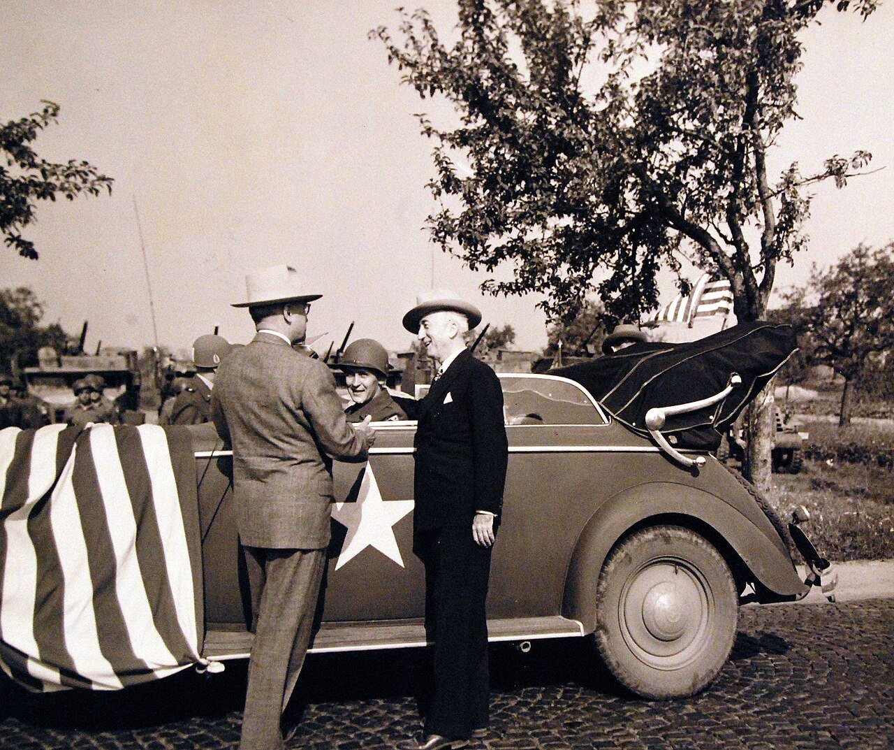80-G-700166: Potsdam Conference, 17 July – 2 August 1945. President Harry S. Truman introducing his driver, Private First Class Warren E. Baker to Secretary of State James F. Byrnes, both from the same home town. President Truman had been inspecting the 3Rd Armored Division near Frankfurt, Germany. Photographed by CPhoM William Belknap Jr., released July 26, 1945. U.S. Navy Photograph, now in the collections of the National Archives. (2016/02/23).