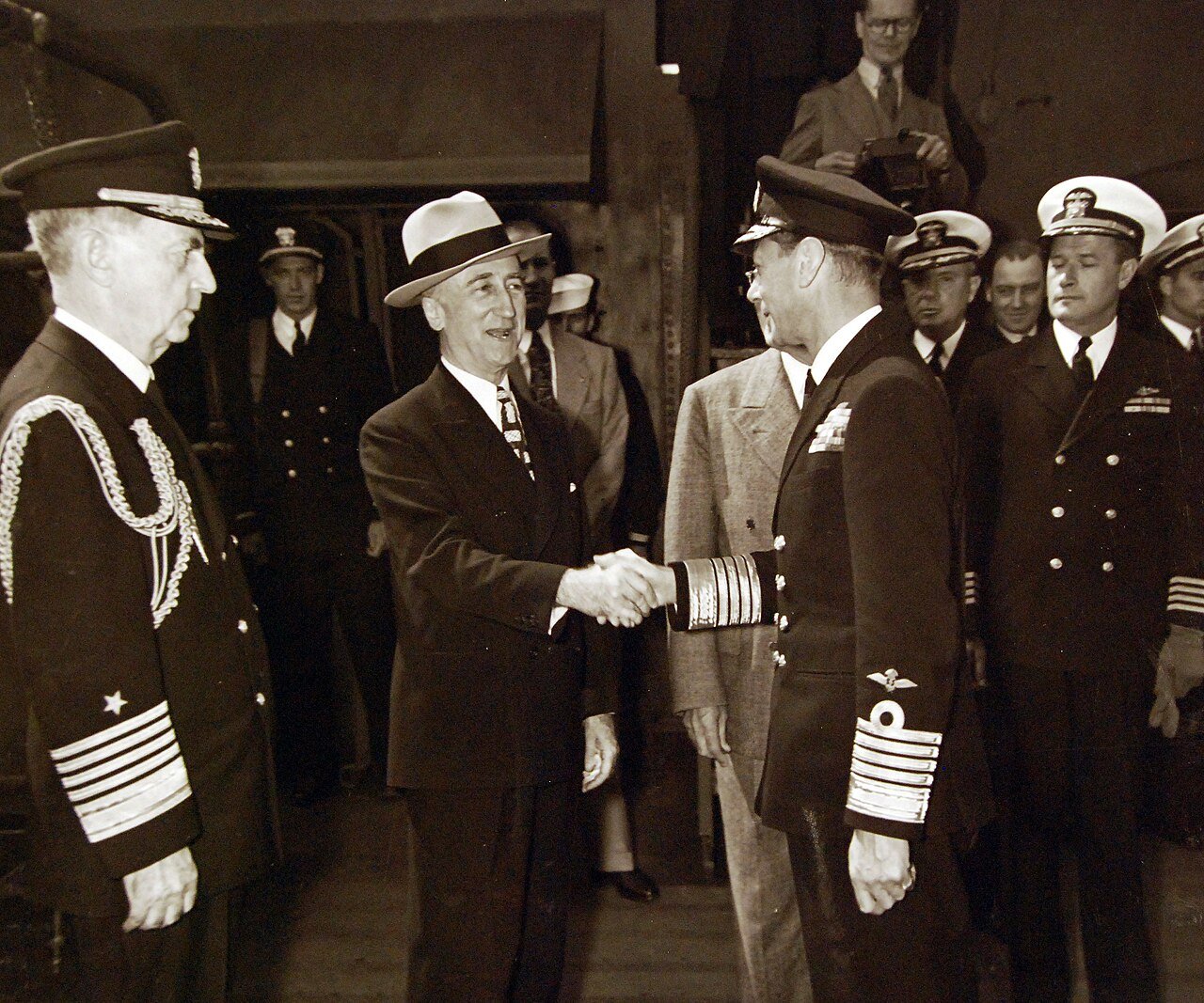 80-G-700231: King George VI aboard USS Augusta (CA 31) for a return visit to President Harry S. Truman while the ship is in Plymouth Harbor, England. Shown: Fleet Admiral William D. Leahy, Secretary of State James F. Byrnes, King George, and Captain James Foskett. Photograph released August 1945. U.S. Navy Photograph, now in the collections of the National Archives. (2016/02/23).