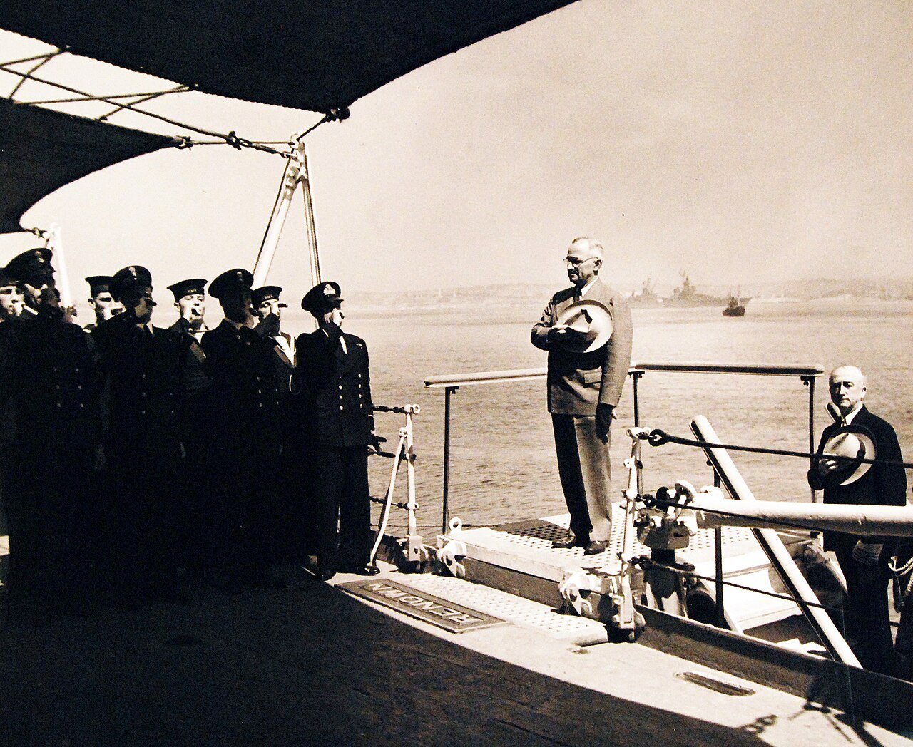 80-G-700236: Potsdam Conference, 17 July – 2 August 1945. President Harry S. Truman pays call on King George onboard his ship, HMS Renown in Plymouth Harbor, England. President Truman receives side honors. Behind him is Secretary of State James F. Byrnes. Photograph released August 2, 1945. U.S. Navy Photograph, now in the collections of the National Archives. (2016/02/23).