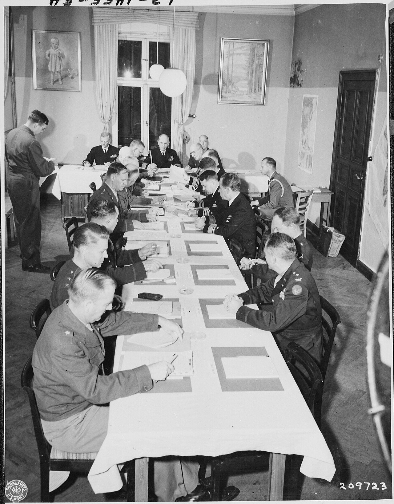 Adm. William Leahy, seated center, at head of table, presides over a meeting of the Joint Chiefs of Staff during the…