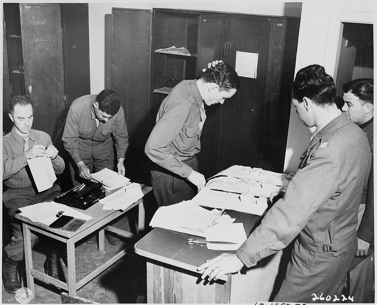 Applicants for passes keep Lt. A. H. Hadden, assistant provost marshal for the Berlin District, of Cleveland, Ohio…