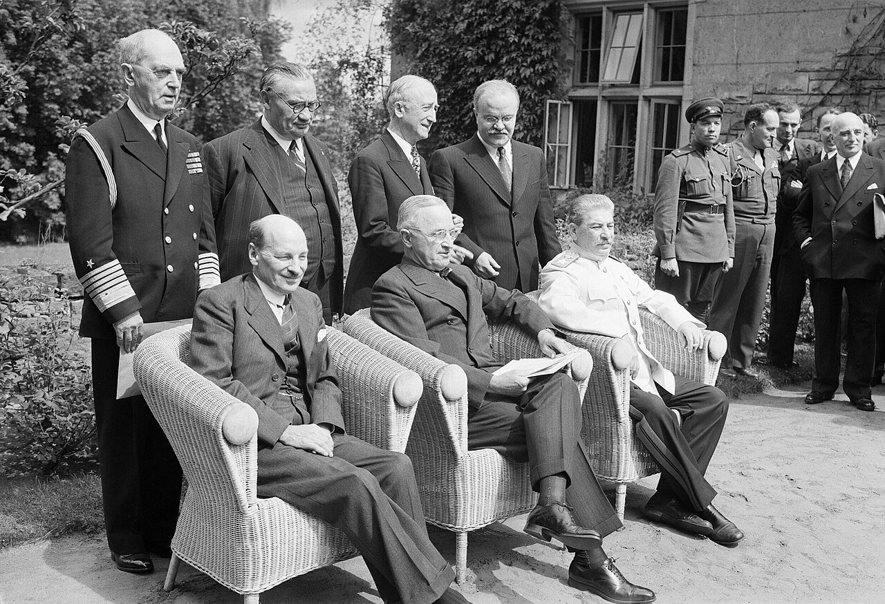 Britain's new Prime Minister, Clement Attlee, with President Truman and Marshal Stalin at the Potsdam Conference in Berlin, 1 August 1945. Clement Attlee with President Truman of the United States and Marshal Stalin of the Soviet Union at the Potsdam Conference in Berlin, shortly after winning the British General election in 1945. Standing from left to right are Admiral Leahy, Ernest Bevin, James Byrnes and Vyacheslav Molotov. The last of the war-time summit conferences was held at Potsdam, outside Berlin from 16 July to 2 August 1945 and the results of the British General Election were announced while it was in session. Churchill and Eden initially headed the British delegation and were accompanied by Attlee who was leader of the opposition at the start of the conference but Prime Minister for the final sessions.