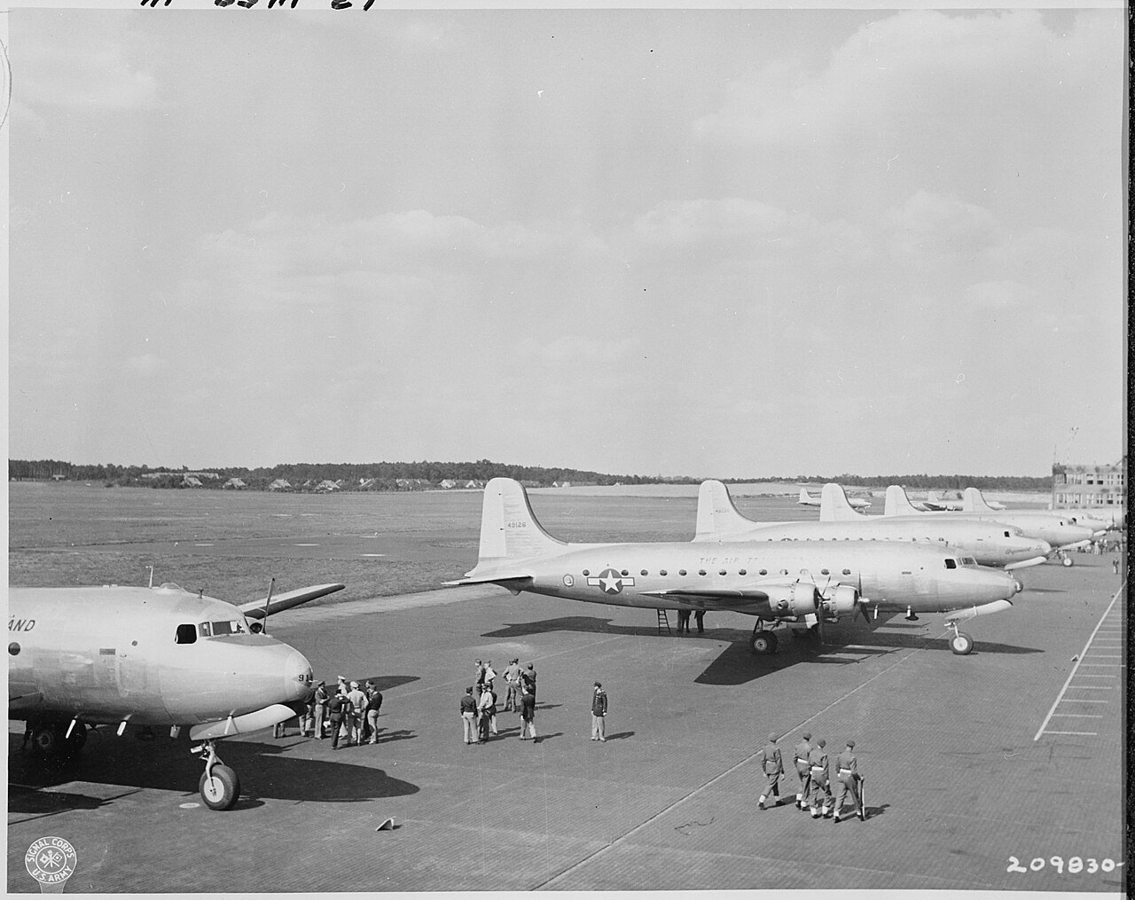 C-54 transports line up after their arrival at Gatow Airport in Berlin, Germany. These planes brought President Harry…