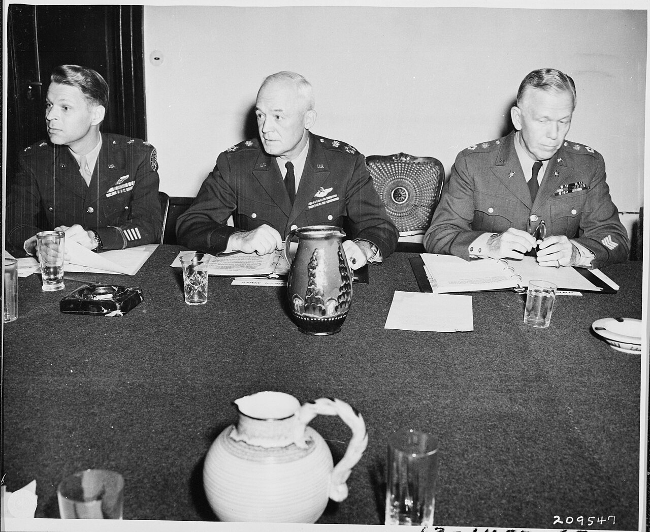 Chiefs of Staff, L to R, Maj. Gen. Lauris Norstad, Gen. Henry H. Arnold, and Gen. George C. Marshall at a meeting…