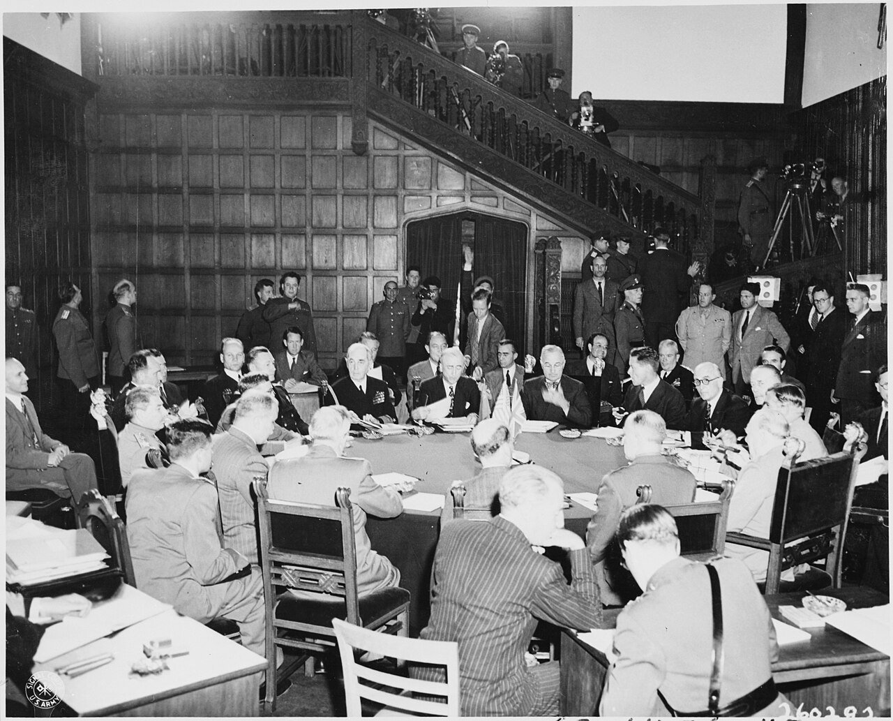 Delegates of the Potsdam Conference in Germany seated around the conference table. Soviet leader Josef Stalin is…