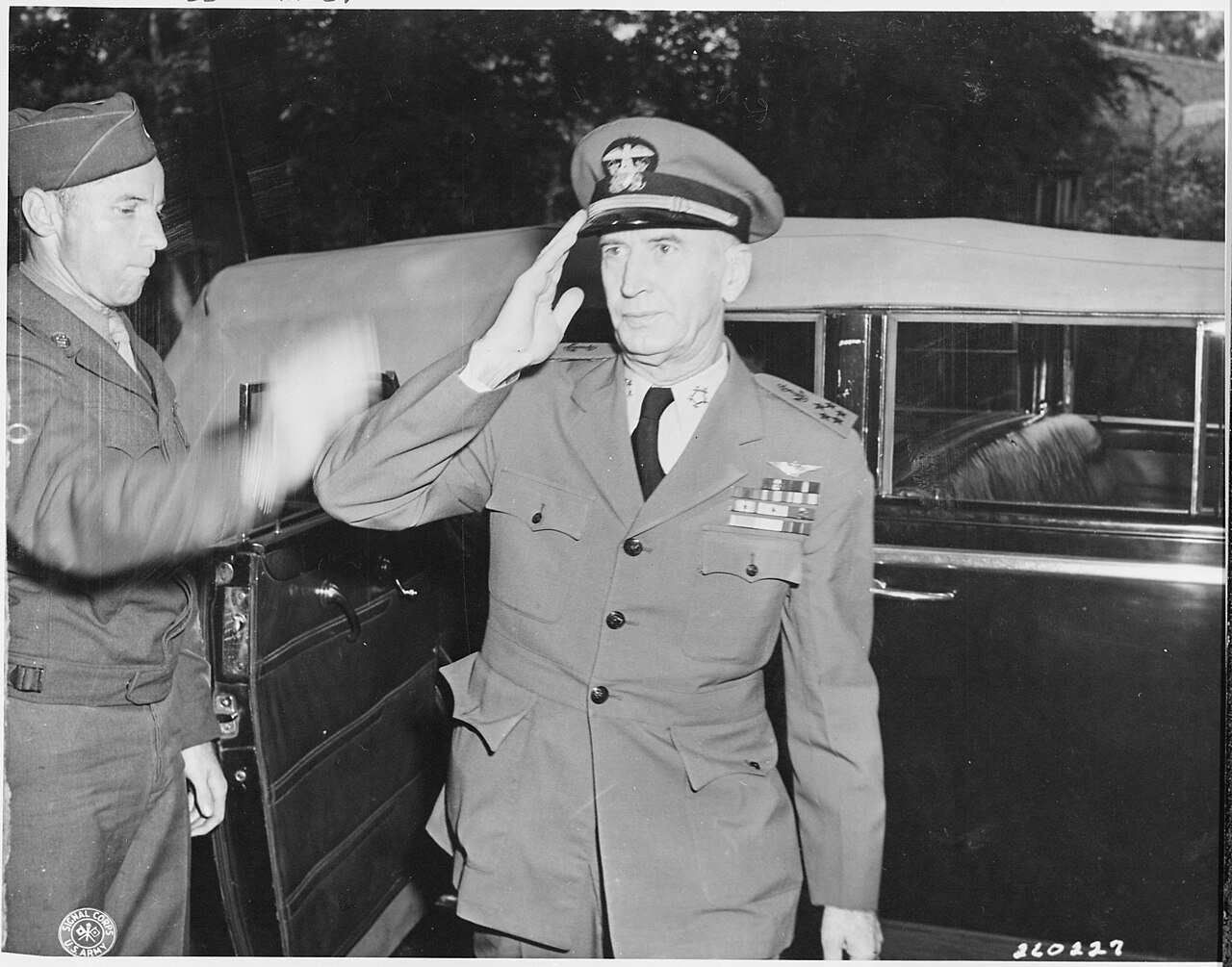 Fleet Admiral Ernest J. King, U. S. Navy, arrives at his quarters and salutes a soldier during the Potsdam Conference…
