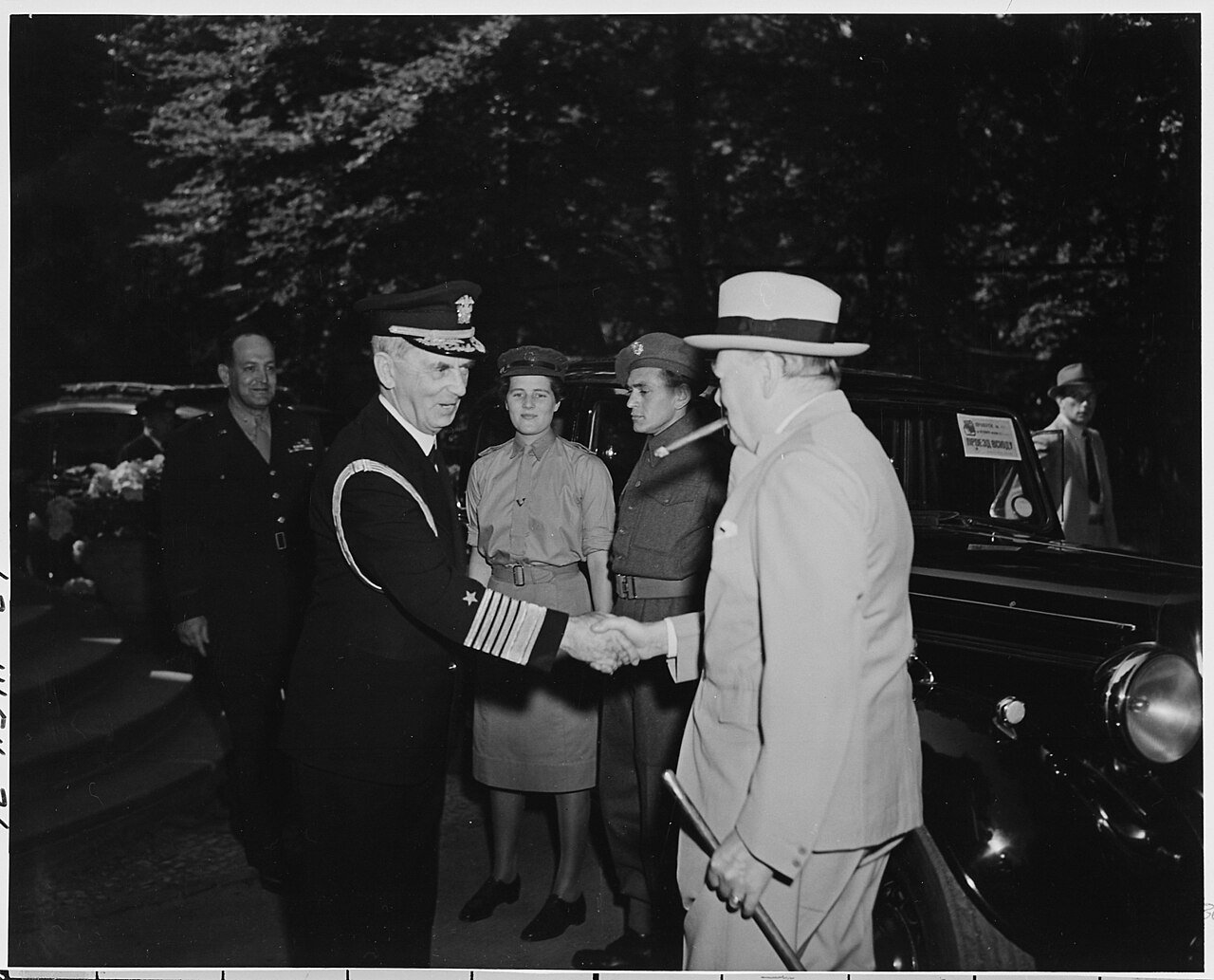 Fleet Admiral William Leahy greets Prime Minister Winston Churchill at the entrance to the "Little White House"…