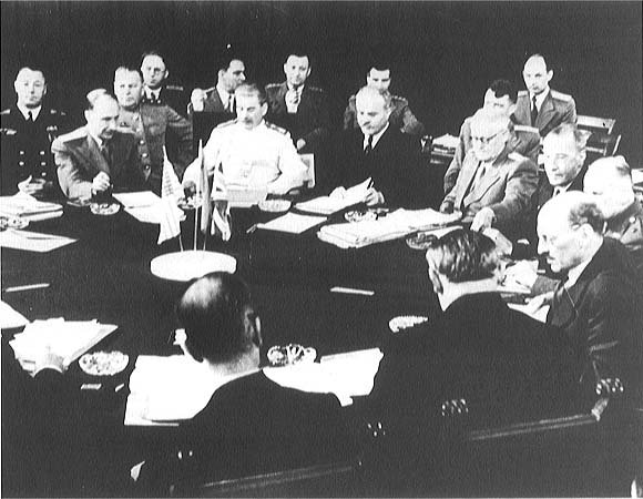 Joseph Stalin (right center, rear in white uniform) listens in on the discussions at the Potsdam Conference in 1945 following the German surrender. The conference was to determine the four-power partition of Germany and the future of Eastern Europe. To Stalin's right is the Soviet foreign minister, Vyachevslav Molotov.