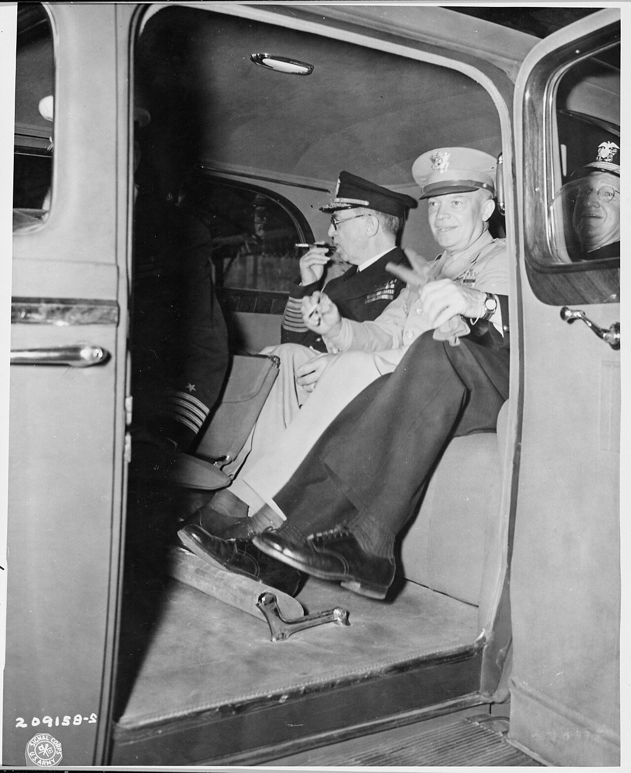 L to R, Adm. Harold Stark and Gen. Dwight D. Eisenhower in car preparing to ride in a procession behind President…
