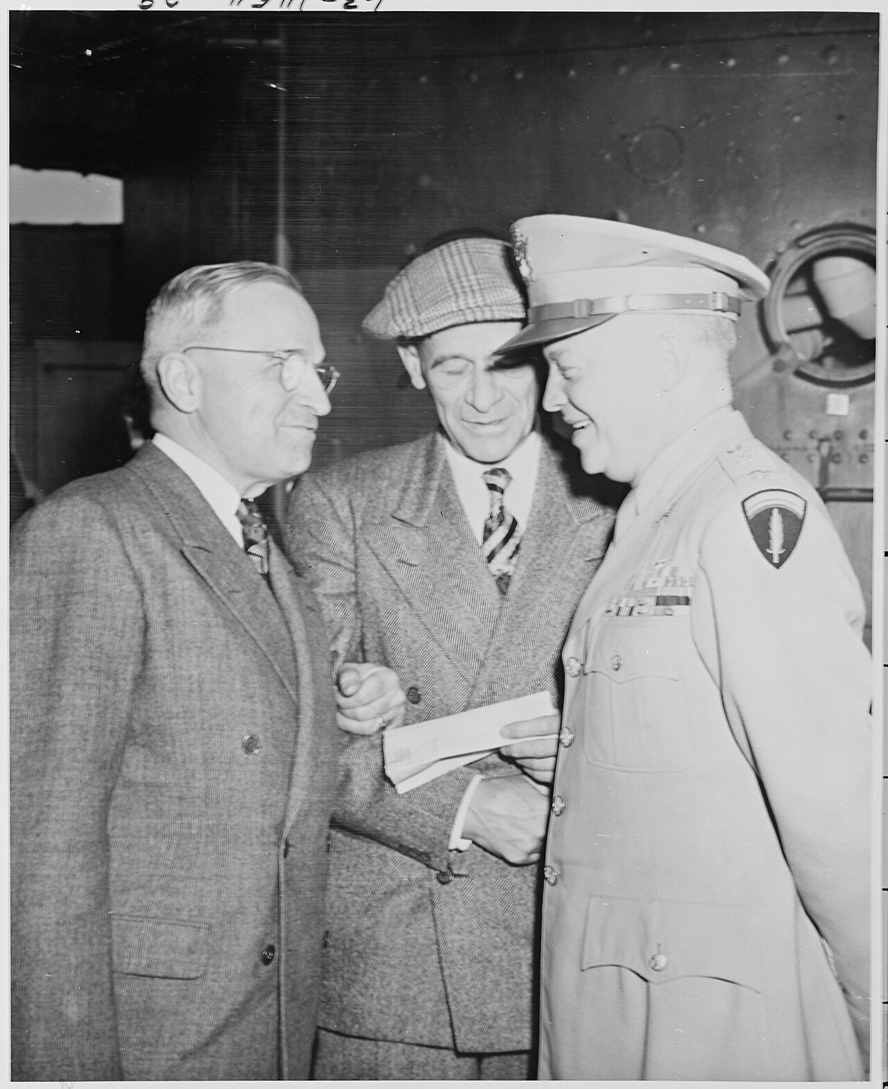 L to R, President Harry S. Truman, Press Secretary Charles Ross, and Gen. Dwight D. Eisenhower chat after President…
