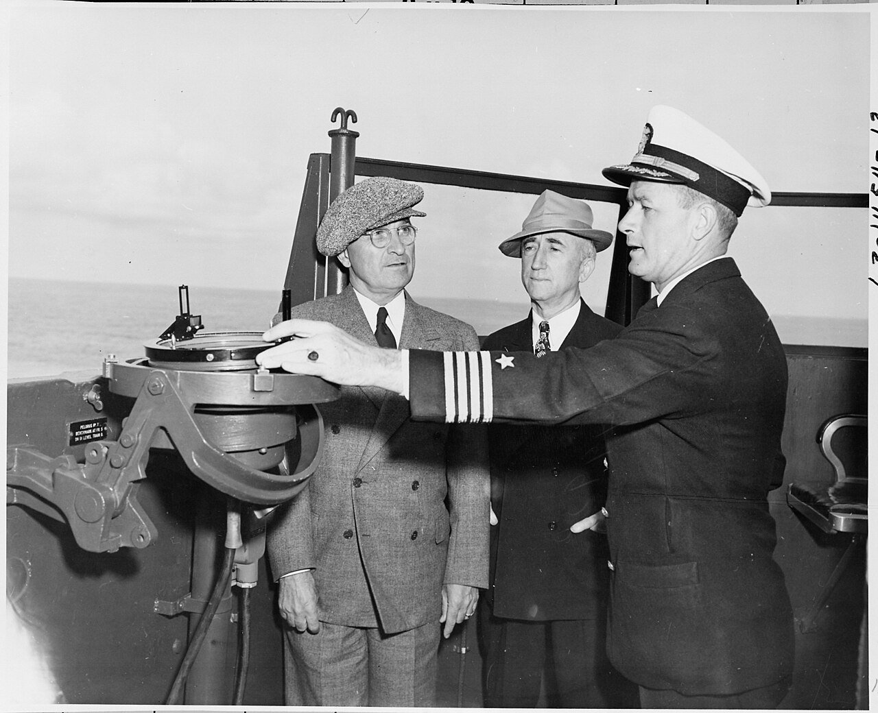 L to R, President Harry S. Truman, Secretary of State James Byrnes, Captain J. H. Foskett, Commanding Officer of the…
