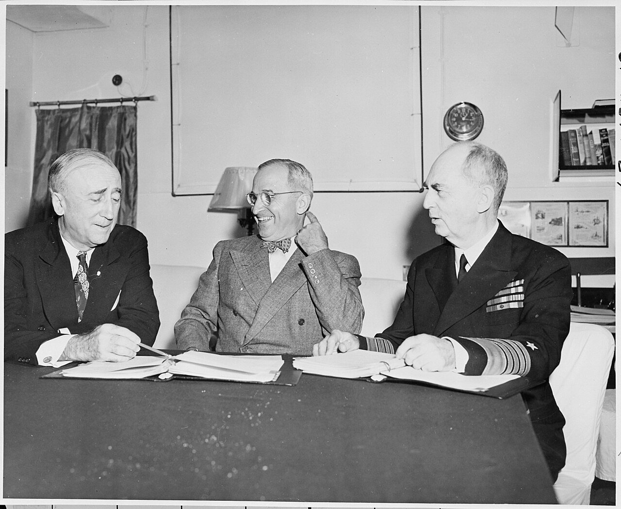 L to R, Secretary of State James Byrnes, President Harry S. Truman, and Adm. William Leahy on board the U. S. S.…