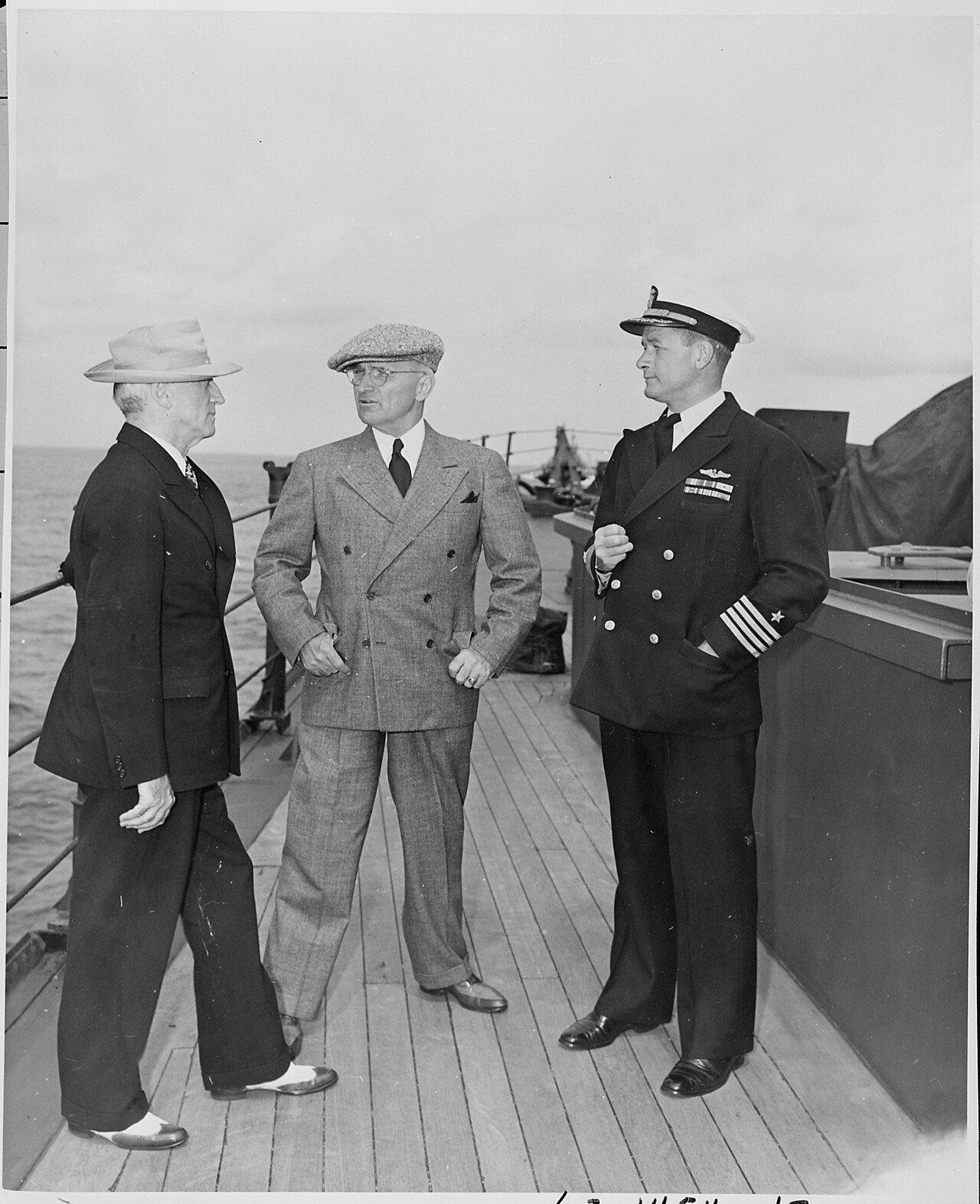 L to R, Secretary of State James Byrnes, President Harry S. Truman, and Captain J. H. Foskett, Commanding Officer of…