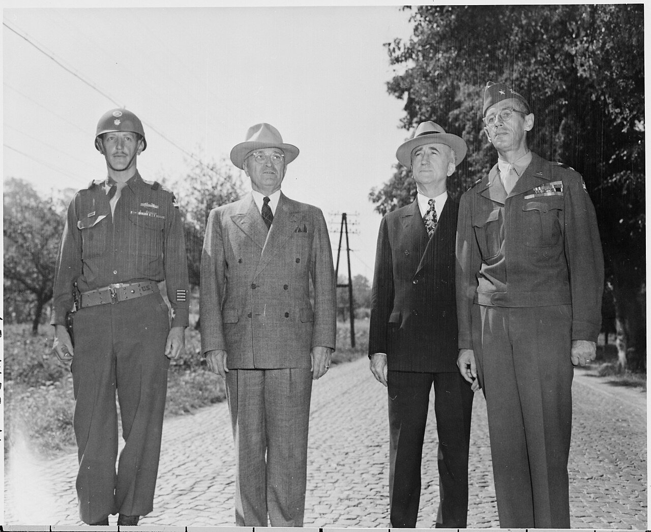 L to R, Unidentified officer, President Harry S. Truman, Secretary of State James Byrnes, and Gen. A. G. Rolling…