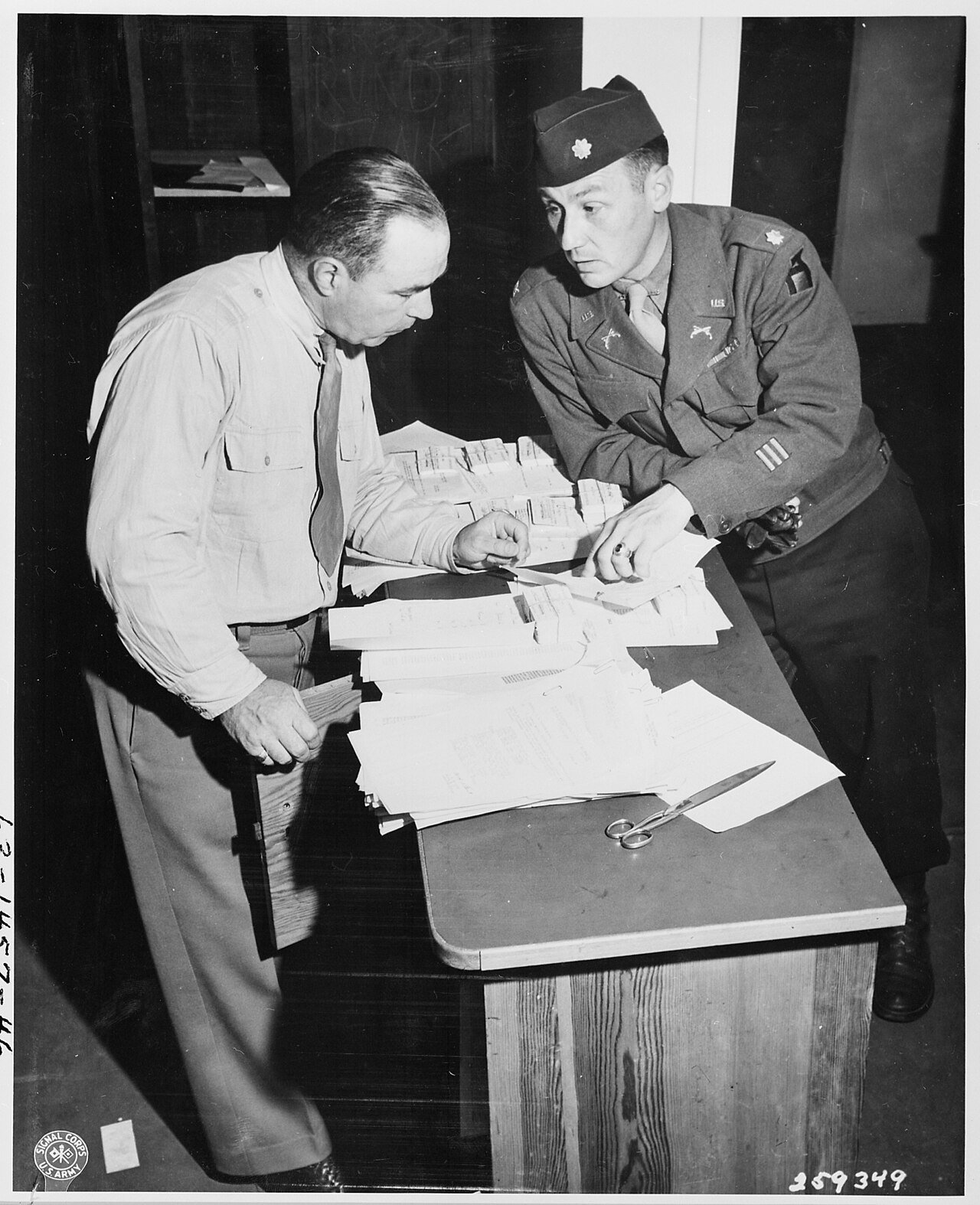 Lt. Col. James P. Smith, Jr. of Ipswich, Massachusetts, Provost Marshall of the Berlin District, left, and Major…