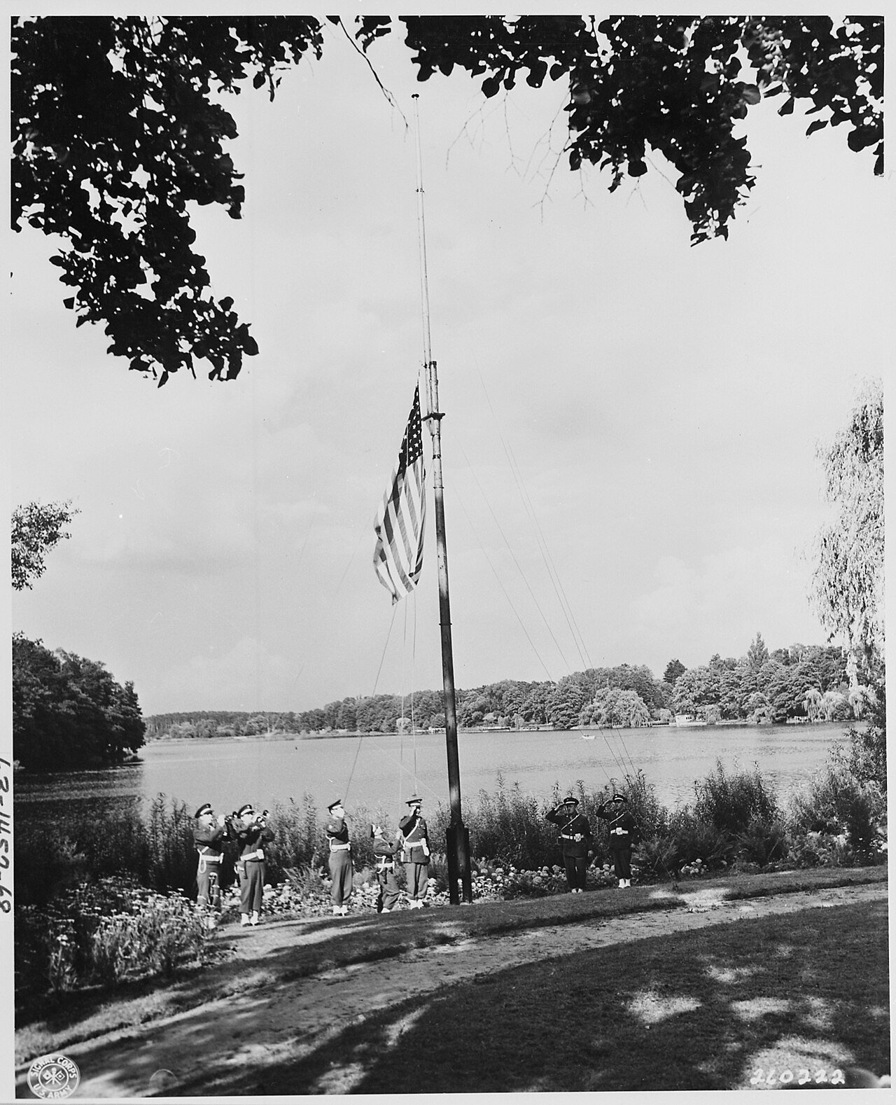 Military police at the end of the day with buglers sounding retreat pull down the U. S. flag at the "Little White…