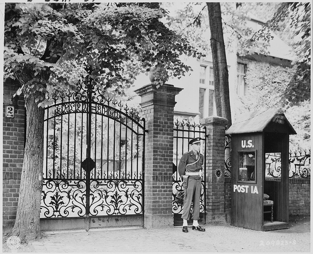 Military Police stand guard at entrance to the "Little White House," residence of President Truman in Babelsberg…