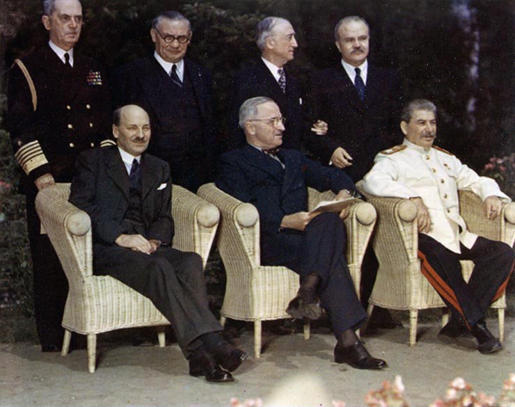 The "Big Three" pose with their principal advisors, at Potsdam, Germany, circa 28 July -- 1 August 1945. The three heads of government are (seated, left to right): British Prime Minister Clement Attlee; U.S. President Harry S. Truman; Soviet Premier Joseph Stalin. Standing behind them are (left to right): Fleet Admiral William D. Leahy, USN, Truman's Chief of Staff; British Foreign Minister Ernest Bevin; U.S. Secretary of State James F. Byrnes; Soviet Foreign Minister Vyacheslav Molotov. Original photo caption: Photo # USA C-1860 "Big Three" & Foreign Ministers at Potsdam, ca. July 1945