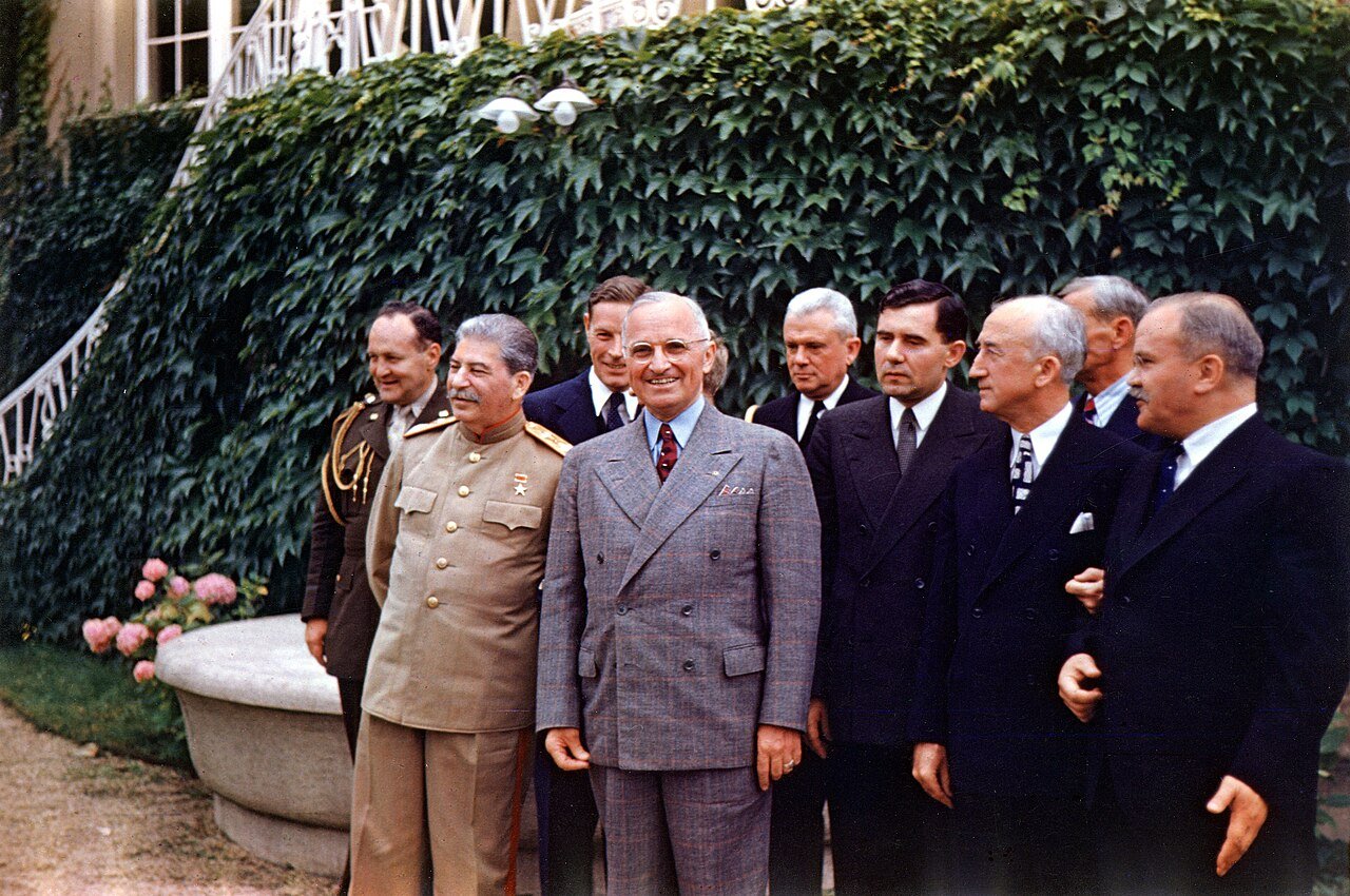 Harry S. Truman and Joseph Stalin meeting at Potsdam. From left to right, row 1 : Joseph Stalin, Harry S. Truman, Soviet Ambassador Andrei Gromyko, Secretary of State James Byrnes, and Soviet Foreign Minister Vyacheslav Molotov. Second row: General Harry Vaughan, interpreter Charles Bohlen, interpreter V. N. Pavlov (mostly obscured by Truman), Captain James K. Vardaman, and Charles Ross (partially obscured).