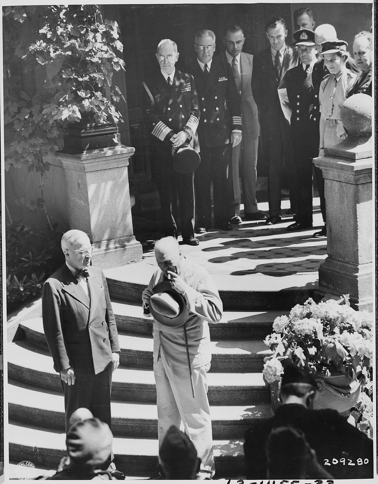 President Truman and British Prime Minister Winston Churchill at the bottom of the stairs of the "Little White…