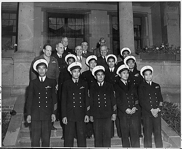 President Truman and members of his party pose on the north steps of the "Little White House," the President's residence in Potsdam, Germany during the Potsdam Conference, with their Filipino stewards. Directly above the uniformed stewards are, L to R: Gen. Harry Vaughan, Adm. William Leahy, Secretary of State James Byrnes, and President Truman. Press Secretary Charles Ross is directly behind President Truman.,
