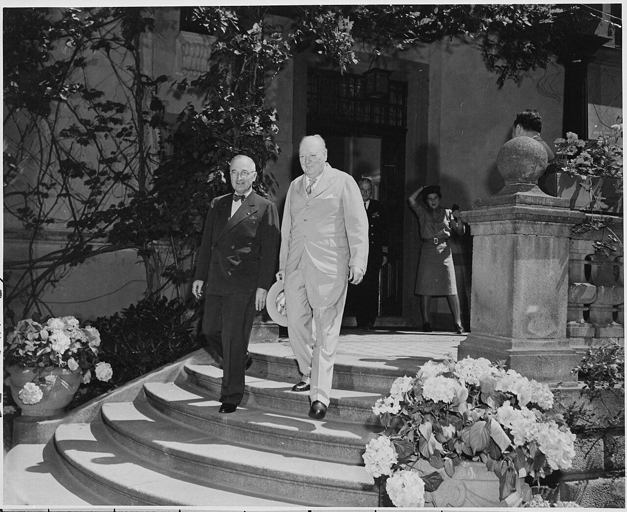 President Truman and Prime Minister Winston Churchill leave the "Little White House," the residence of President…