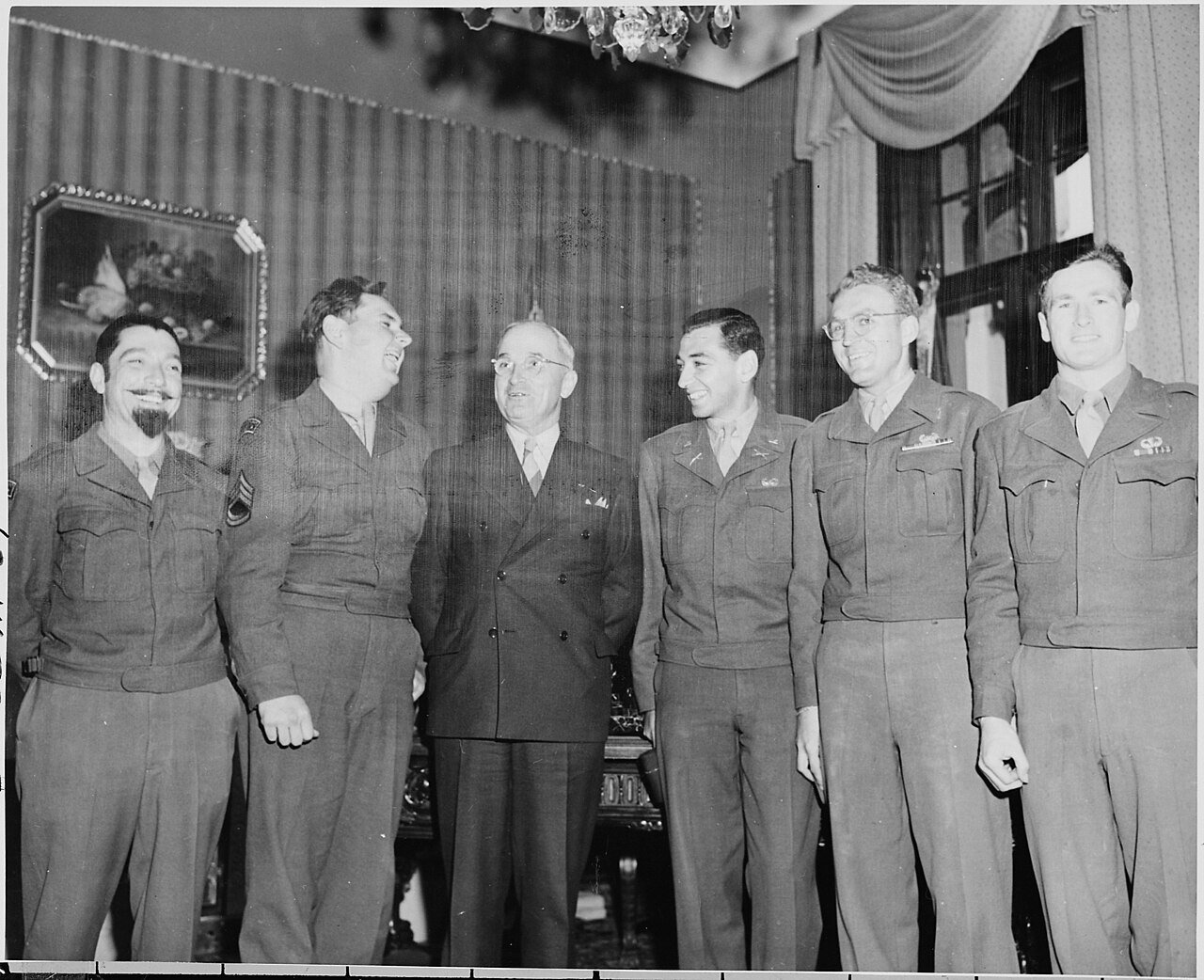 President Truman (third from left) poses with correspondents and photographers of the Stars and Stripes publicaton in…