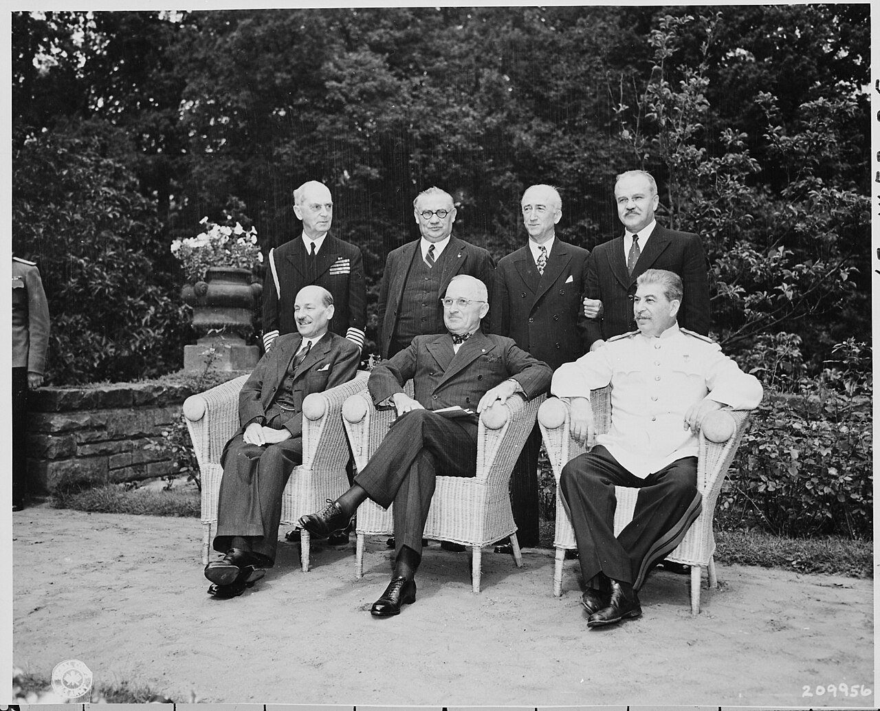 Seated in the garden of Cecilienhof Palace in Potsdam, Germany, L to R, British Prime Minister Clement Attlee…