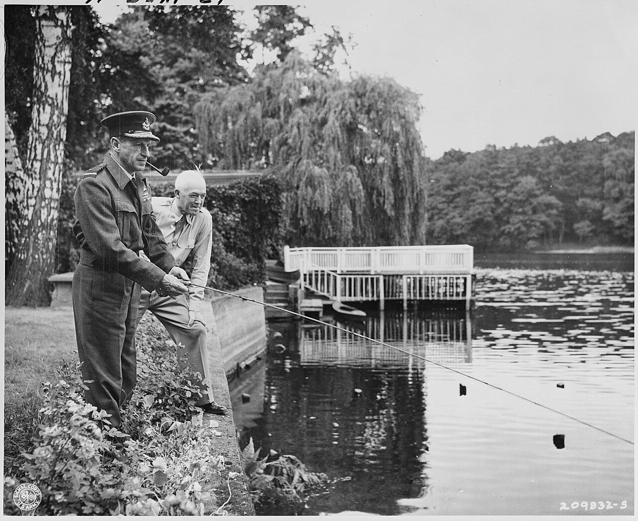 Sir Charles Portal (holding fishing rod), Marshal of the Royal Air Force, and Gen. Henry "Hap" Arnold, Commanding…