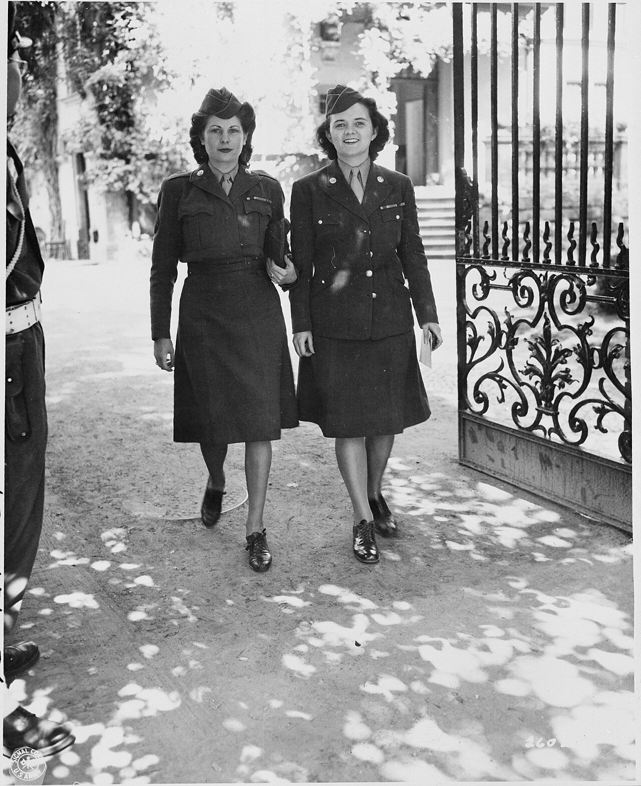 WAC telephone operators Cpl. Alma Bradley and Cpl. Eleanor Moynihan leaving the "Little White House," residence of…