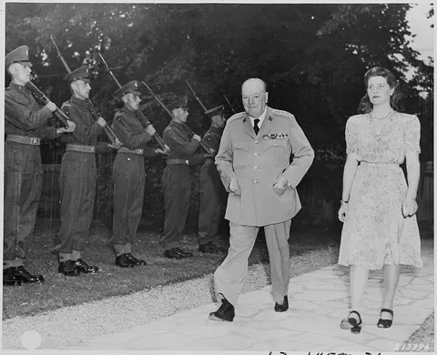 British Prime Minister Winston Churchill and his daughter, Mary, walk in the garden of their residence during the…