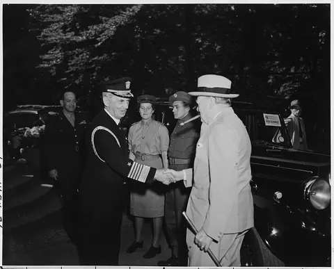 Fleet Admiral William Leahy greets Prime Minister Winston Churchill at the entrance to the "Little White House"…