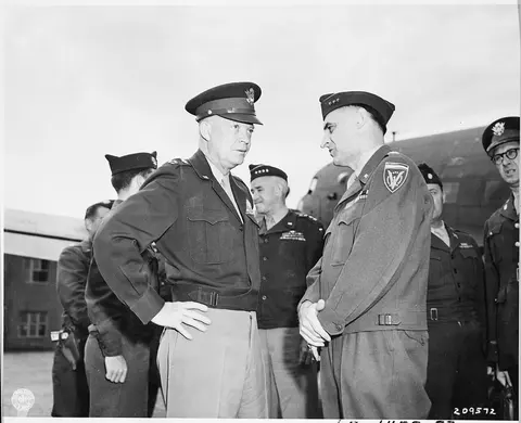 Gen. Dwight D. Eisenhower talks with Lt. Gen. Lucius B. Clay at Gatow Airport in Berlin, Germany during the Potsdam…
