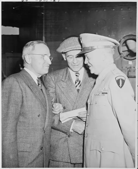 L to R, President Harry S. Truman, Press Secretary Charles Ross, and Gen. Dwight D. Eisenhower chat after President…