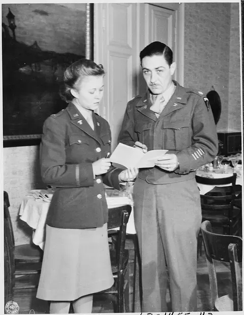 Major John E. Lennox, Chief of all American messes, discusses the day's menu with Lt. May kFelts, dietician at the…