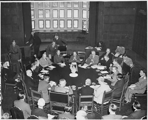 Opening session of the Potsdam Conference in Potsdam, Germany. President Harry S. Truman is seated foreground (back…