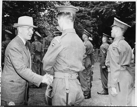 President Harry S. Truman shakes hands with Guardsman Campbell of the Second Battalian, Scot's Guard of Honor, while…
