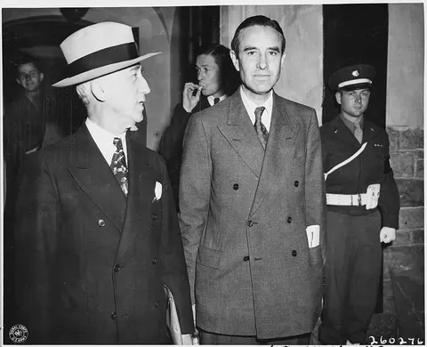 Secretary of State James Byrnes and Averell Harriman leave the Cecilienhof Palace, scene of the Potsdam Conference in…