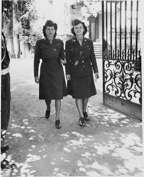WAC telephone operators Cpl. Alma Bradley and Cpl. Eleanor Moynihan leaving the "Little White House," residence of…